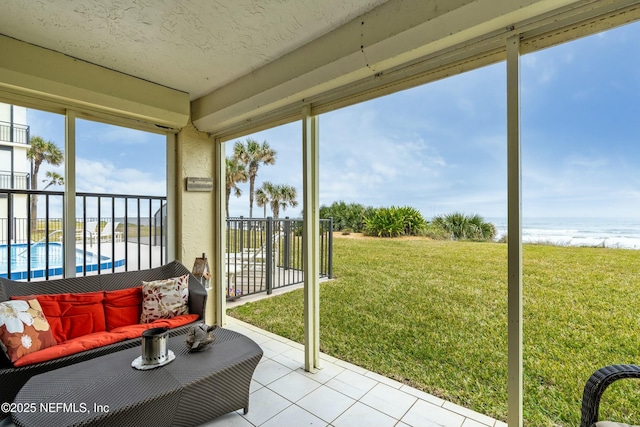 unfurnished sunroom with a water view