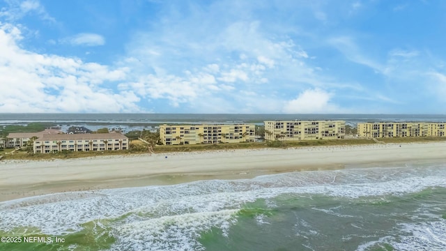 birds eye view of property with a beach view and a water view