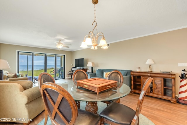 dining room featuring ceiling fan with notable chandelier, ornamental molding, and light hardwood / wood-style floors