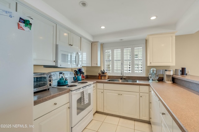 kitchen with white cabinetry, white appliances, sink, and light tile patterned floors