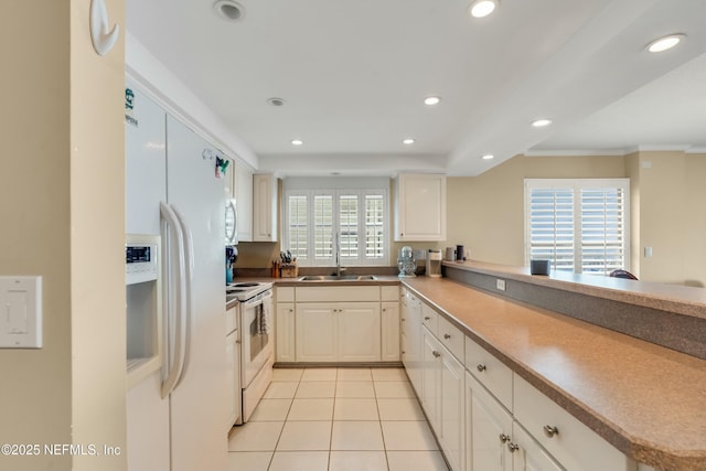 kitchen with light tile patterned flooring, sink, white cabinets, kitchen peninsula, and white appliances