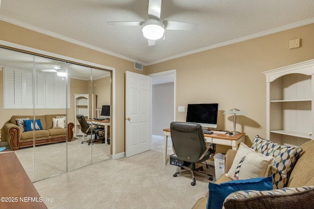 home office with crown molding, ceiling fan, carpet floors, and a textured ceiling