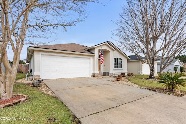 ranch-style house featuring central AC unit, a garage, and a front lawn