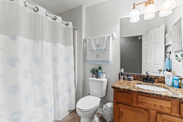 bathroom featuring vanity, toilet, tile patterned flooring, and a textured ceiling