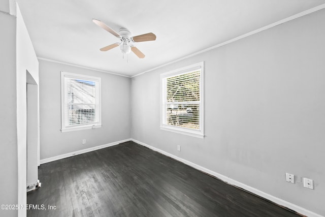 empty room with ornamental molding, dark wood-type flooring, and ceiling fan