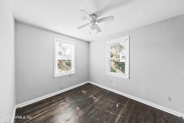 empty room featuring ceiling fan and dark hardwood / wood-style flooring