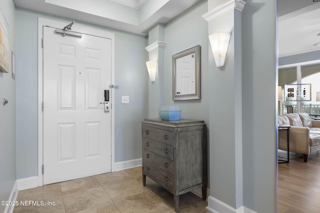 entryway featuring crown molding