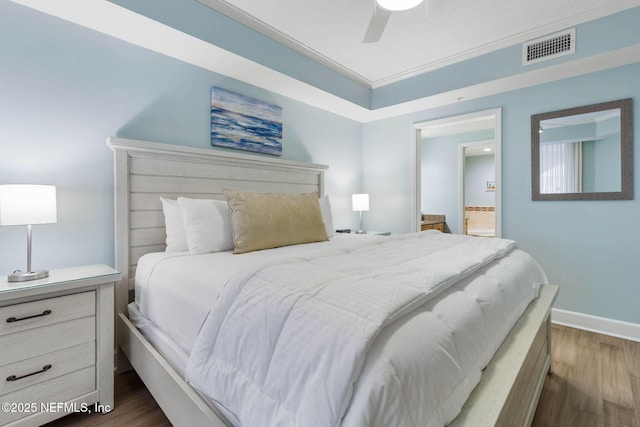 bedroom featuring crown molding, ceiling fan, and dark hardwood / wood-style flooring