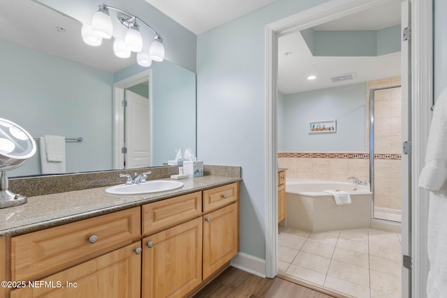 bathroom featuring vanity, tile patterned floors, and plus walk in shower