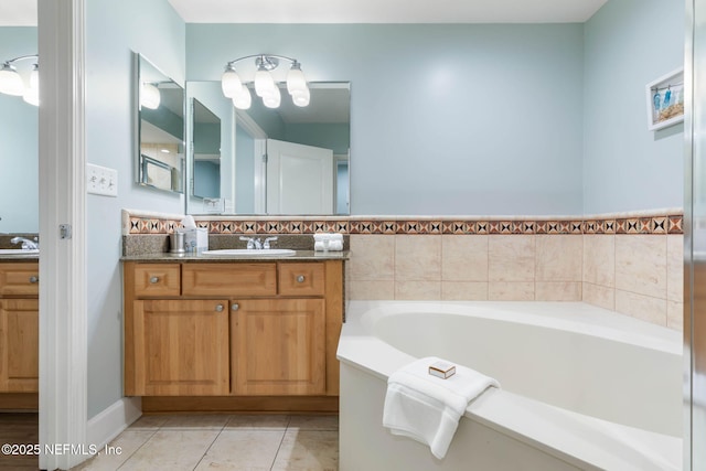 bathroom with vanity, tile patterned floors, and a tub