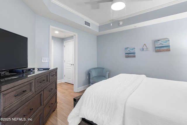 bedroom with crown molding, ceiling fan, and light hardwood / wood-style flooring