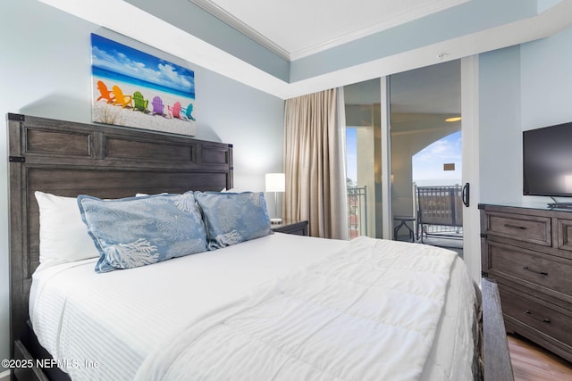 bedroom featuring hardwood / wood-style flooring and crown molding