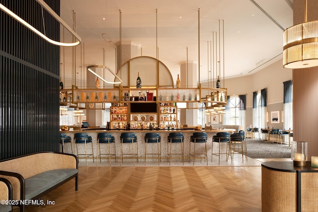 bar featuring parquet floors and a high ceiling