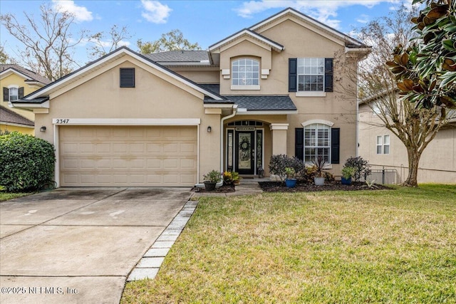 view of front property featuring a garage and a front yard