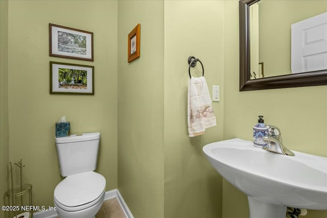 bathroom featuring sink, tile patterned floors, and toilet