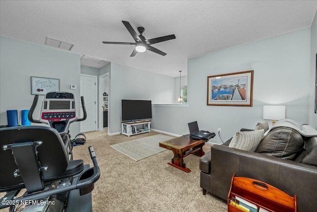 carpeted living room with ceiling fan and a textured ceiling