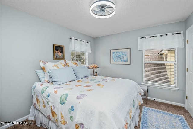 bedroom with a textured ceiling and carpet