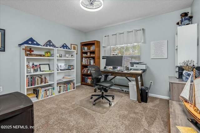 carpeted home office featuring a textured ceiling