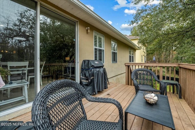 wooden deck with a grill