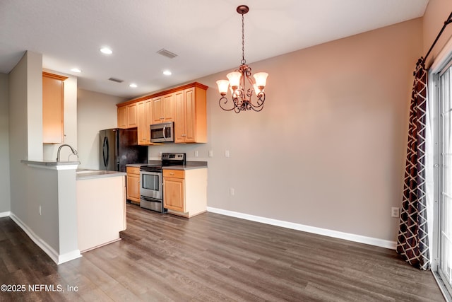 kitchen featuring an inviting chandelier, appliances with stainless steel finishes, dark hardwood / wood-style floors, and light brown cabinets