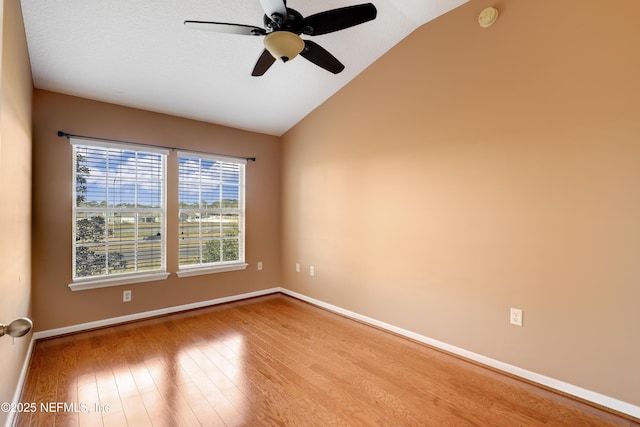 spare room featuring vaulted ceiling, ceiling fan, and light hardwood / wood-style floors