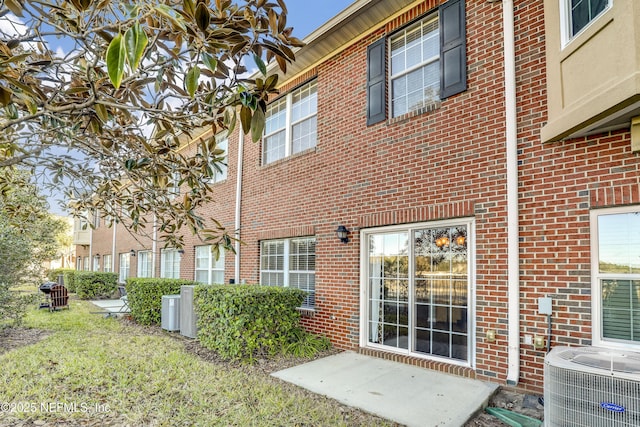 back of property featuring central AC unit