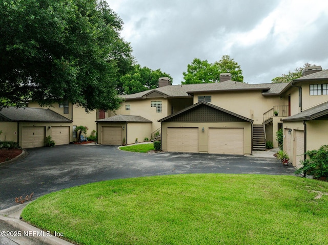 view of front of home featuring a garage and a front lawn