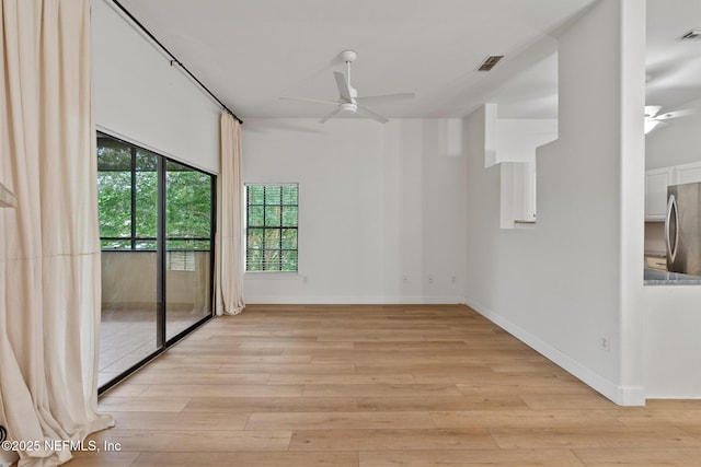 spare room with ceiling fan and light hardwood / wood-style flooring