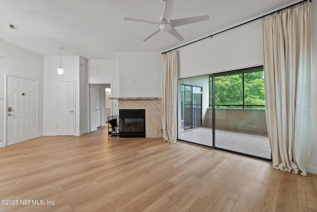 unfurnished living room with ceiling fan and light wood-type flooring