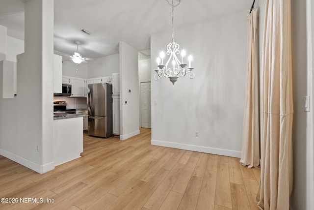 kitchen featuring white cabinetry, ceiling fan with notable chandelier, light hardwood / wood-style flooring, and stainless steel appliances