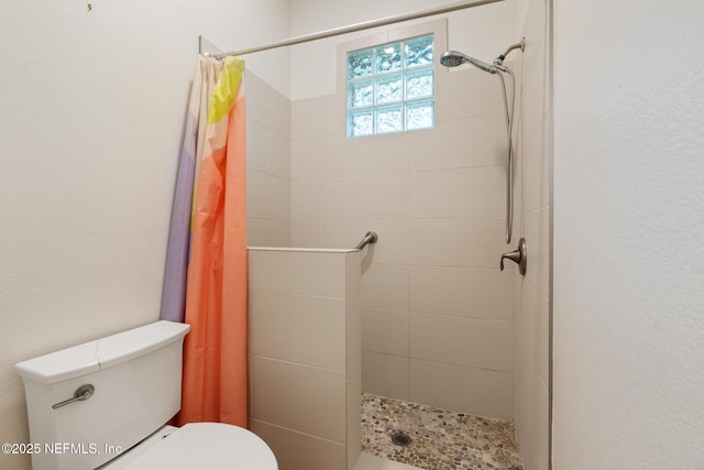 bathroom with walk in shower and toilet