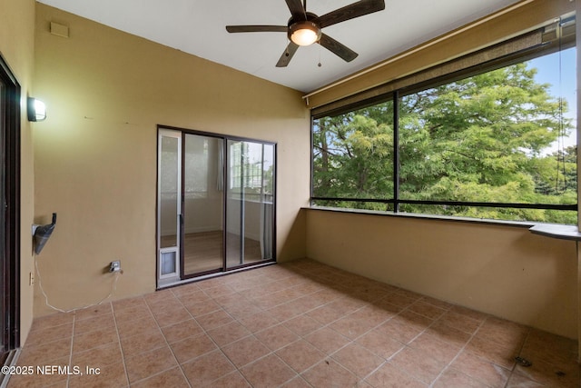 unfurnished sunroom featuring ceiling fan