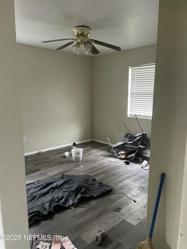 empty room with dark wood-type flooring and ceiling fan