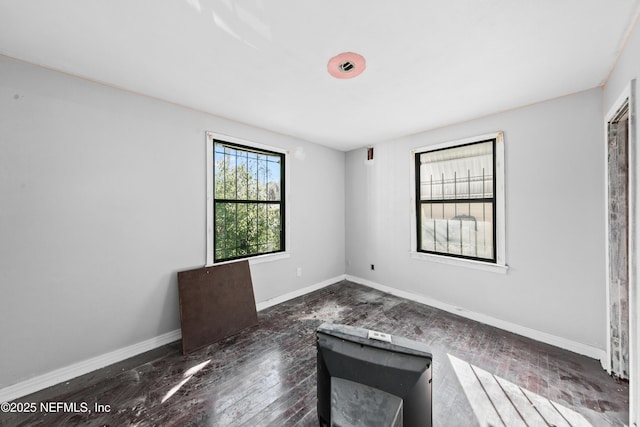 unfurnished room featuring dark wood-type flooring