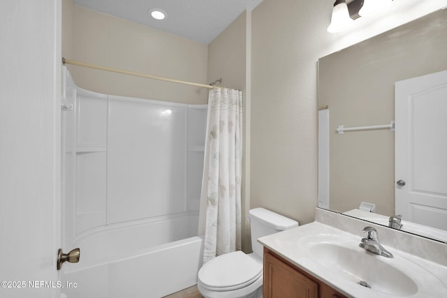 full bathroom with vanity, shower / tub combo, and toilet