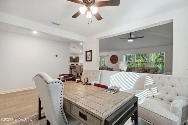 dining room with ceiling fan and light hardwood / wood-style floors