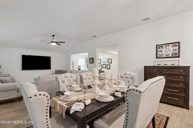 dining area with vaulted ceiling, light hardwood / wood-style floors, and ceiling fan