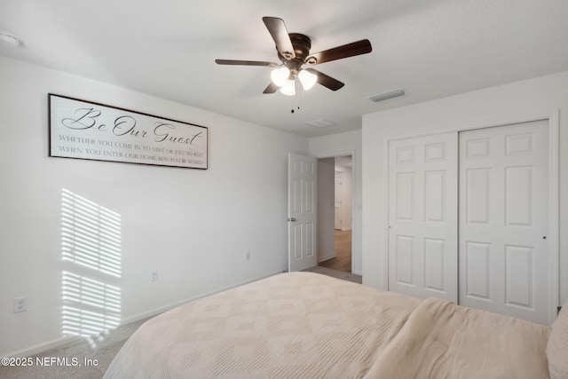 carpeted bedroom with a closet and ceiling fan