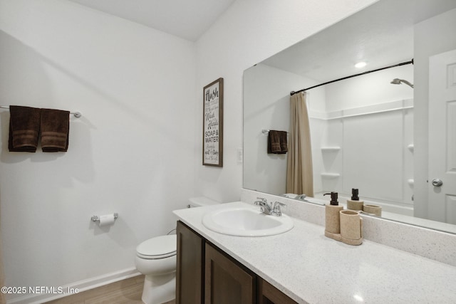 bathroom featuring vanity, hardwood / wood-style flooring, curtained shower, and toilet