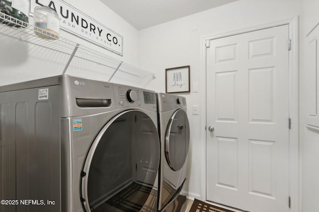 washroom with washing machine and dryer