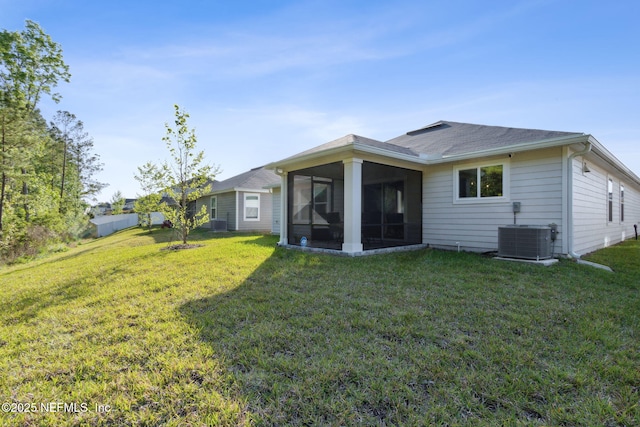 back of house with cooling unit, a yard, and a sunroom