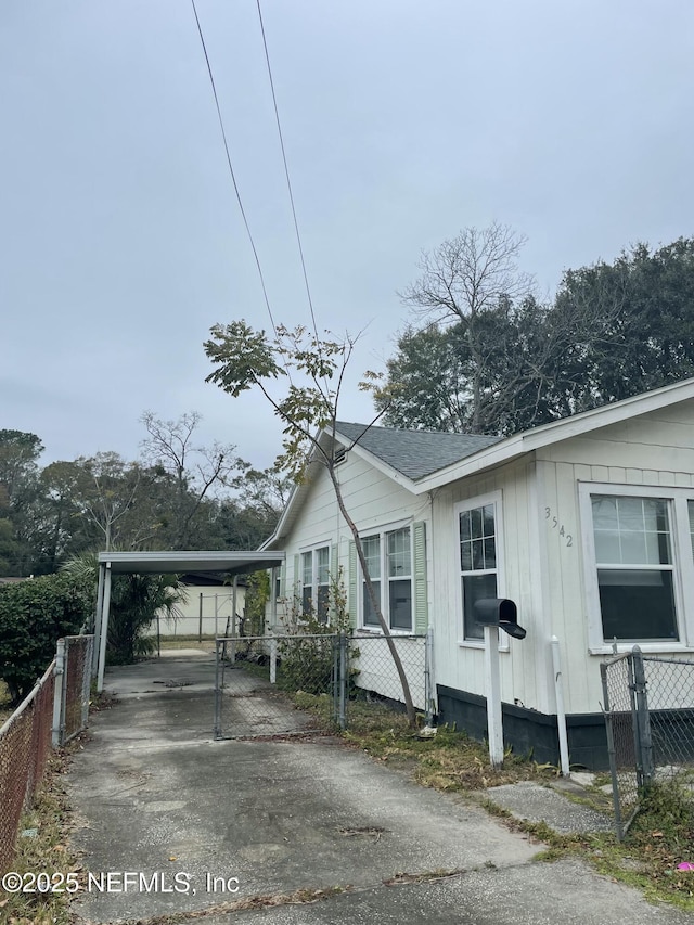 view of side of home with a carport