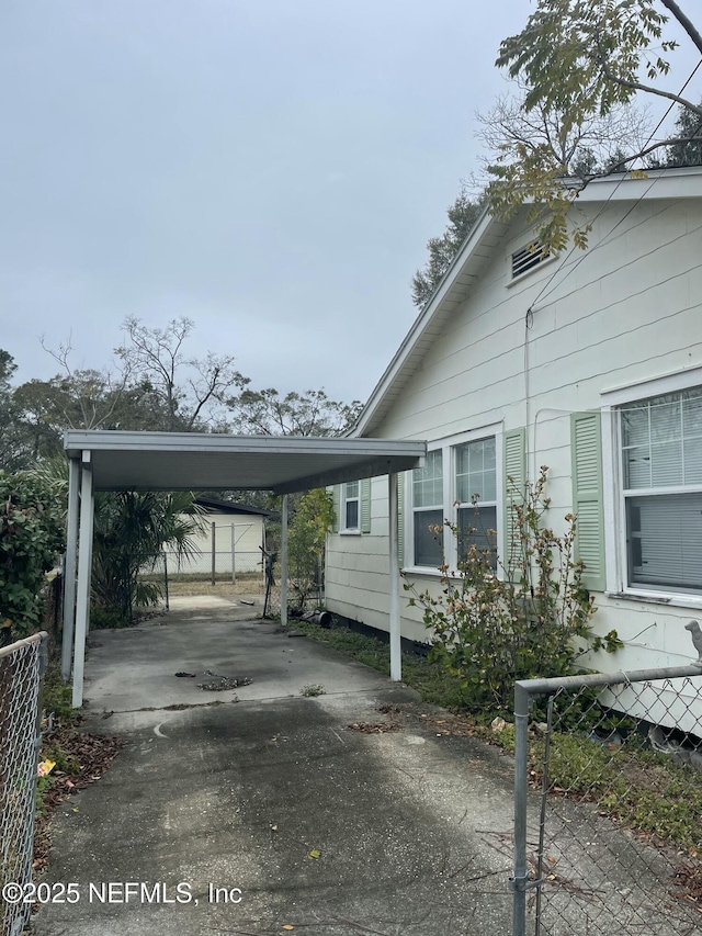 view of side of home featuring a carport