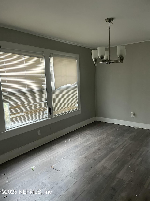 unfurnished dining area with hardwood / wood-style flooring and a chandelier