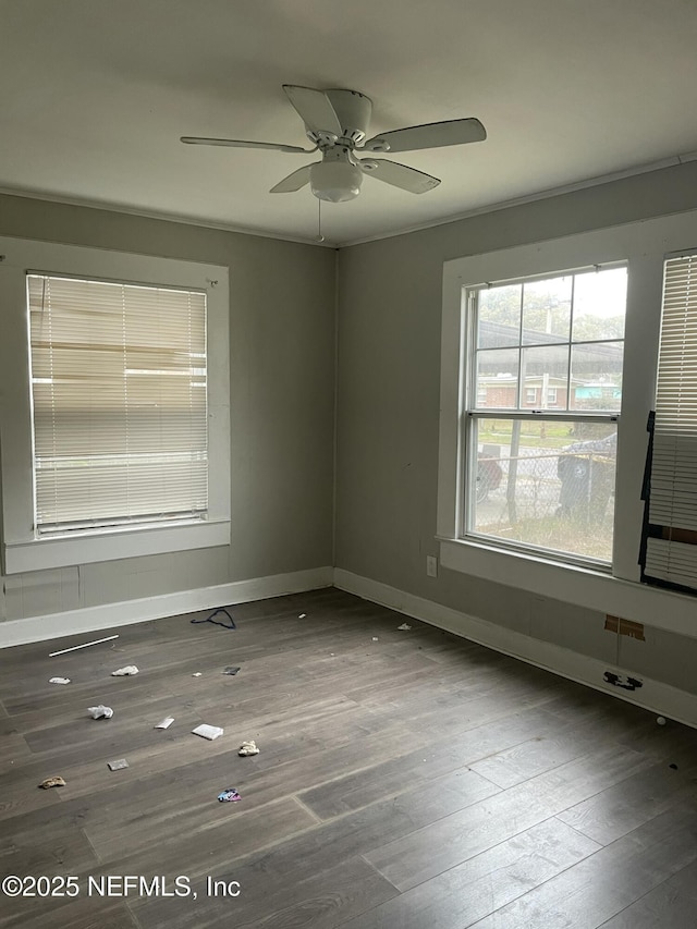 unfurnished room with dark hardwood / wood-style flooring and ceiling fan