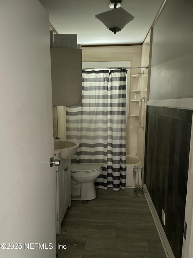 full bathroom with vanity, shower / bath combo with shower curtain, and toilet