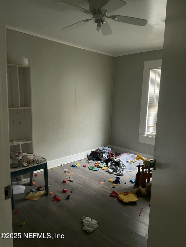 unfurnished bedroom featuring hardwood / wood-style floors, ornamental molding, and ceiling fan