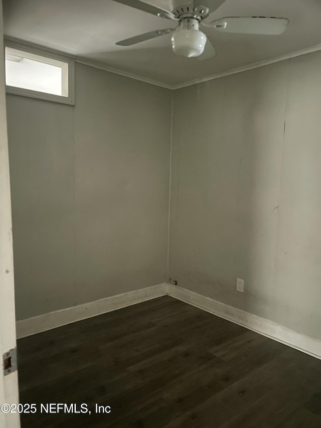 spare room with ceiling fan, ornamental molding, and dark hardwood / wood-style flooring