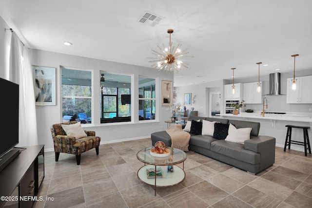 living room with sink and a notable chandelier