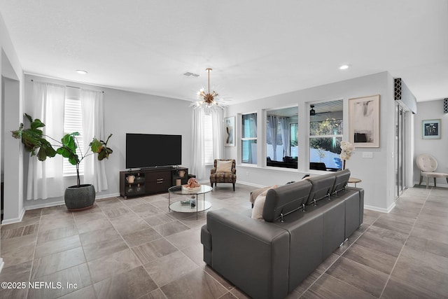 living room with plenty of natural light and a notable chandelier